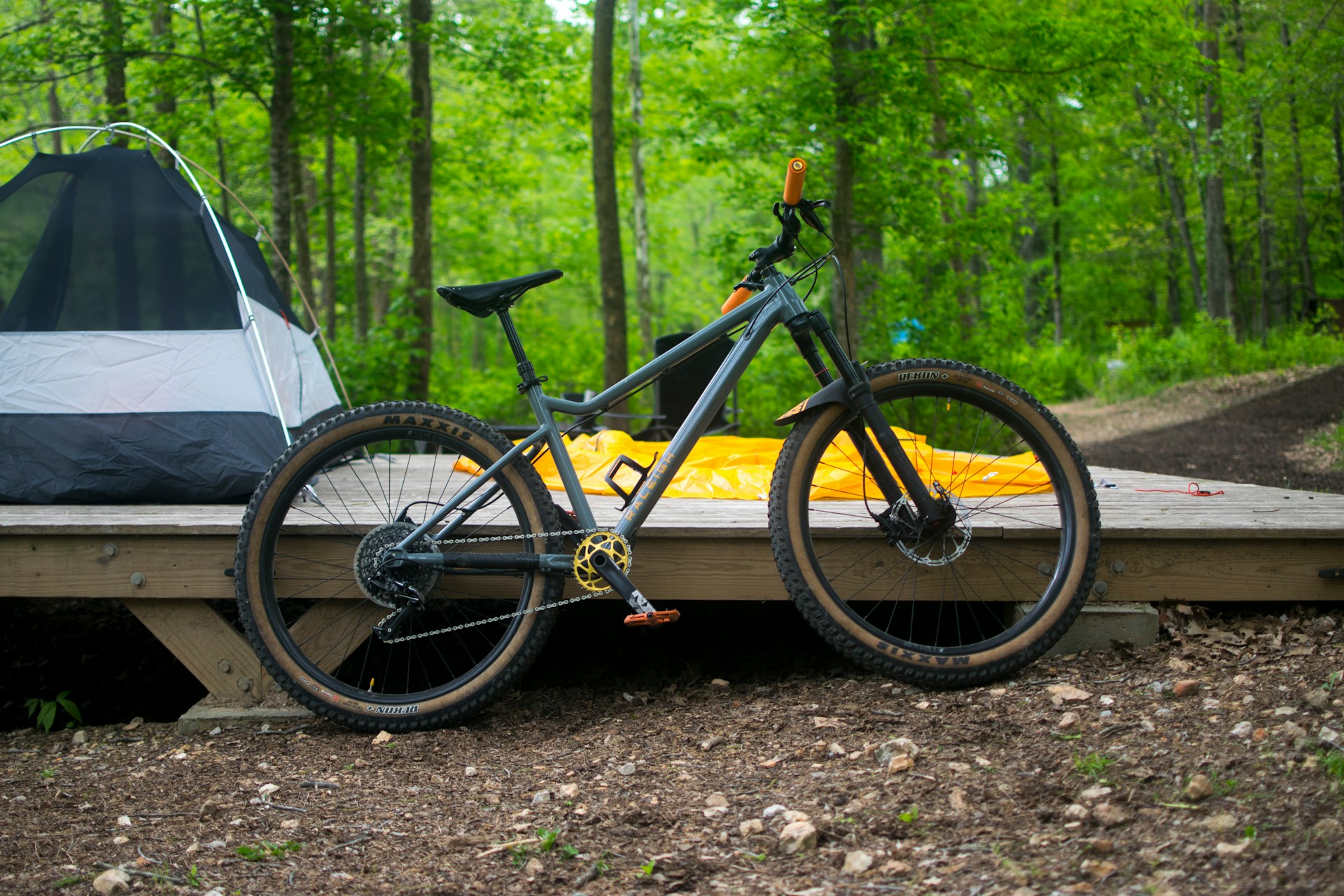 Bicycle leaning on a kayak in the woods